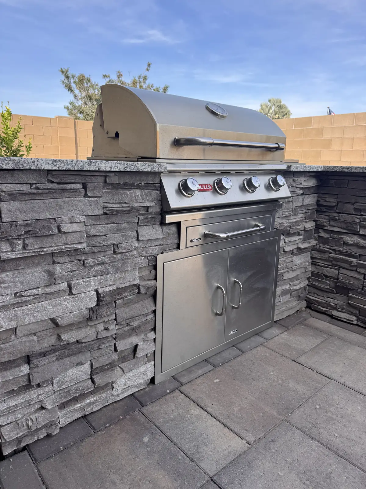 Outdoor kitchen built in grill stone veneer