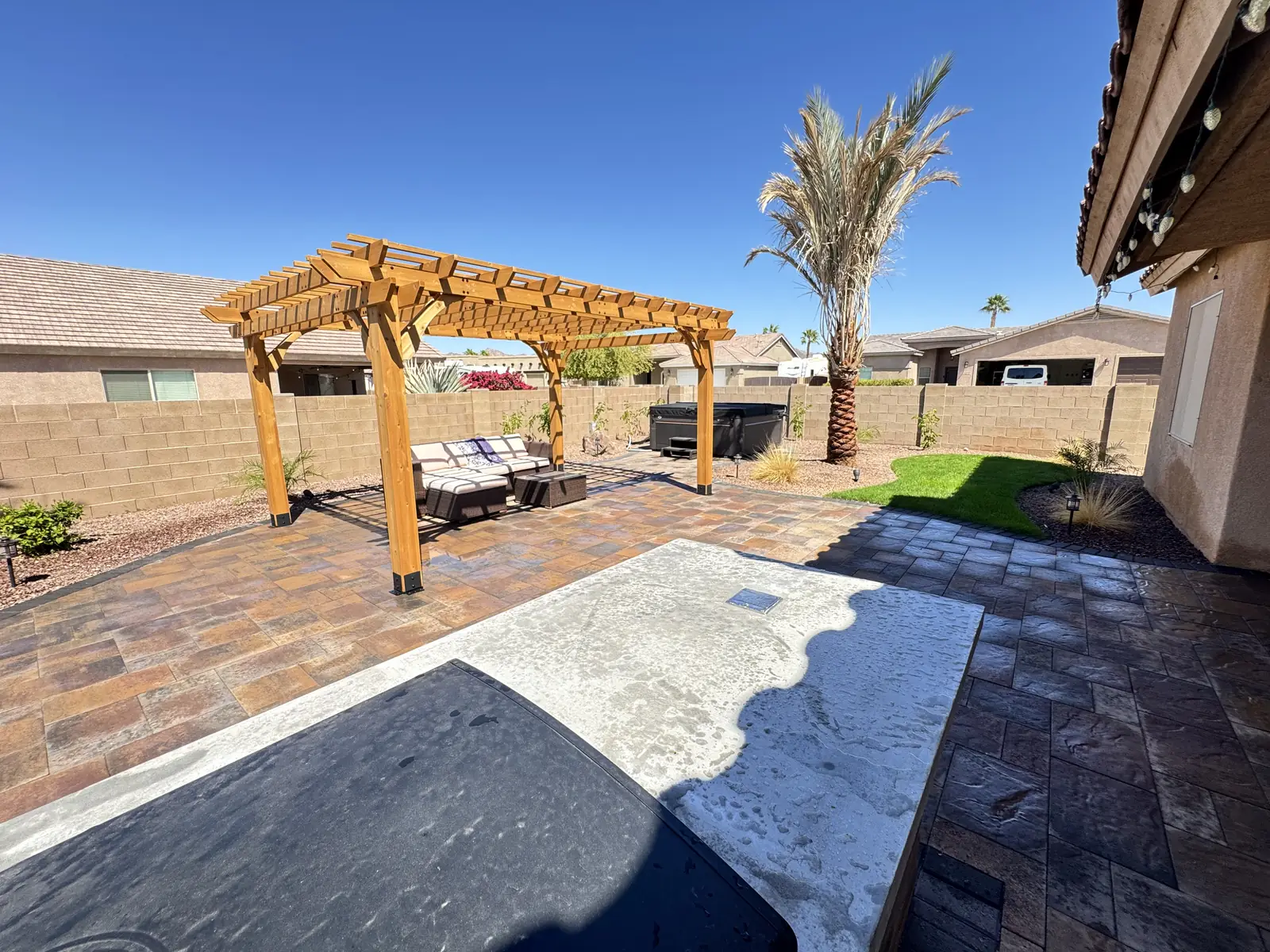 Wood pergola paver patio wide view
