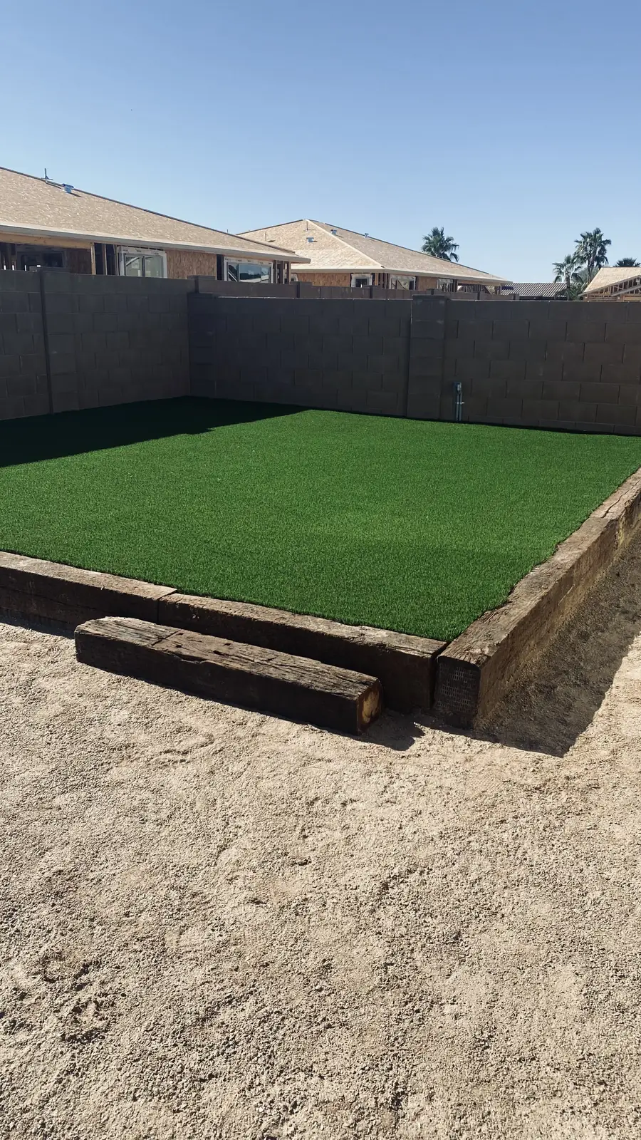 Artificial turf backyard block wall