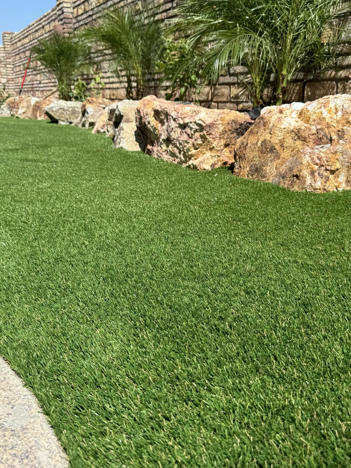 Artificial turf boulder border