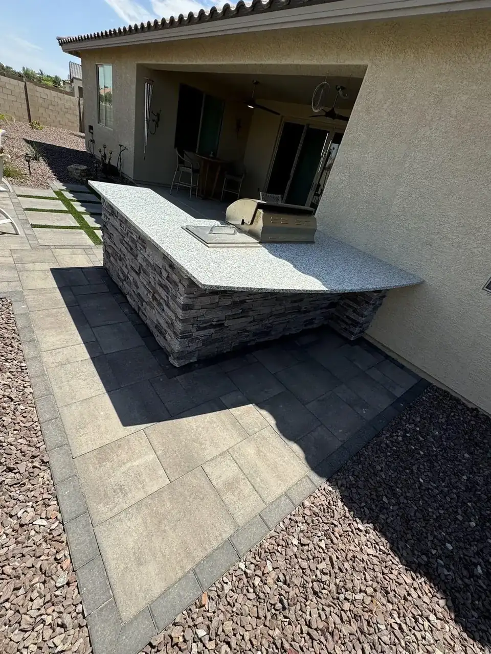 Stainless built-in grill on stone kitchen