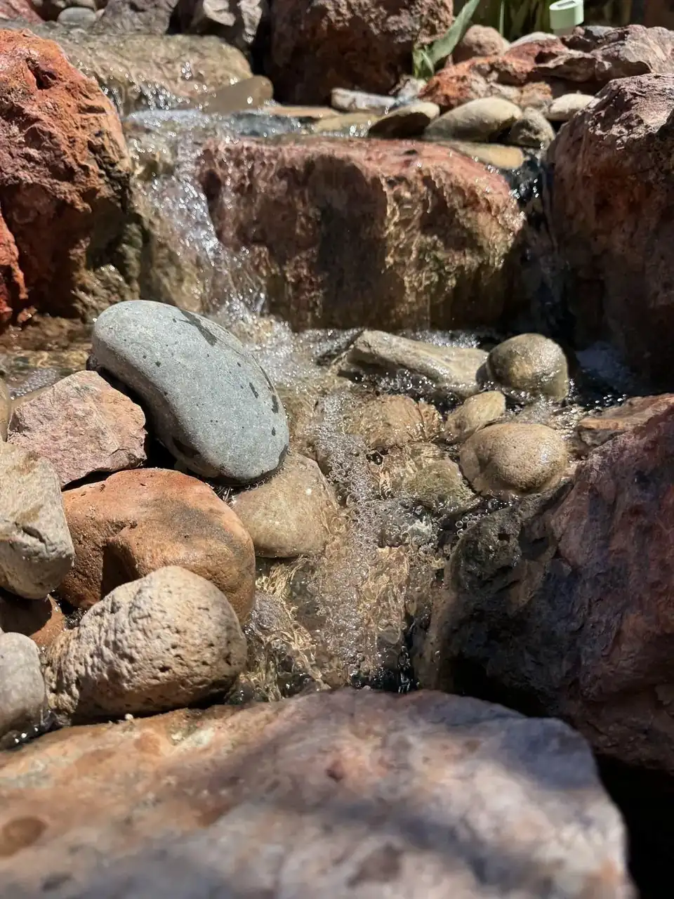 Waterfall detail through natural boulders