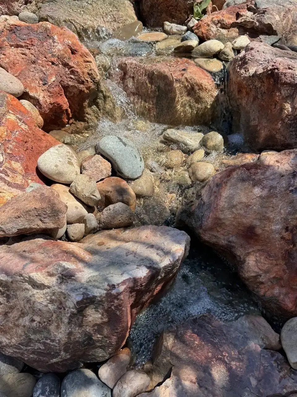 Waterfall dropping into river stone